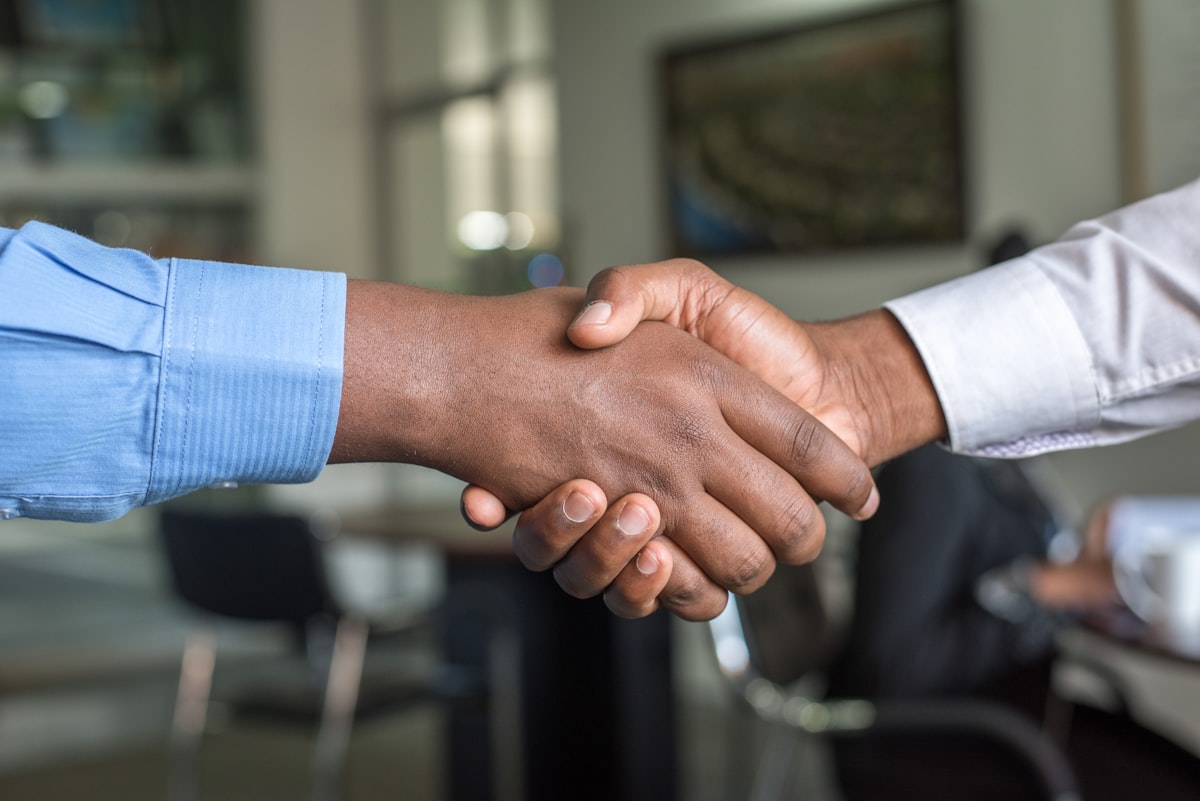 Parties shake hands after reaching agreement in an in-person mediation in Lufkin