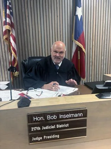 Retired 217th District Judge Bob Inselmann seated on the bench in his Texas courtroom